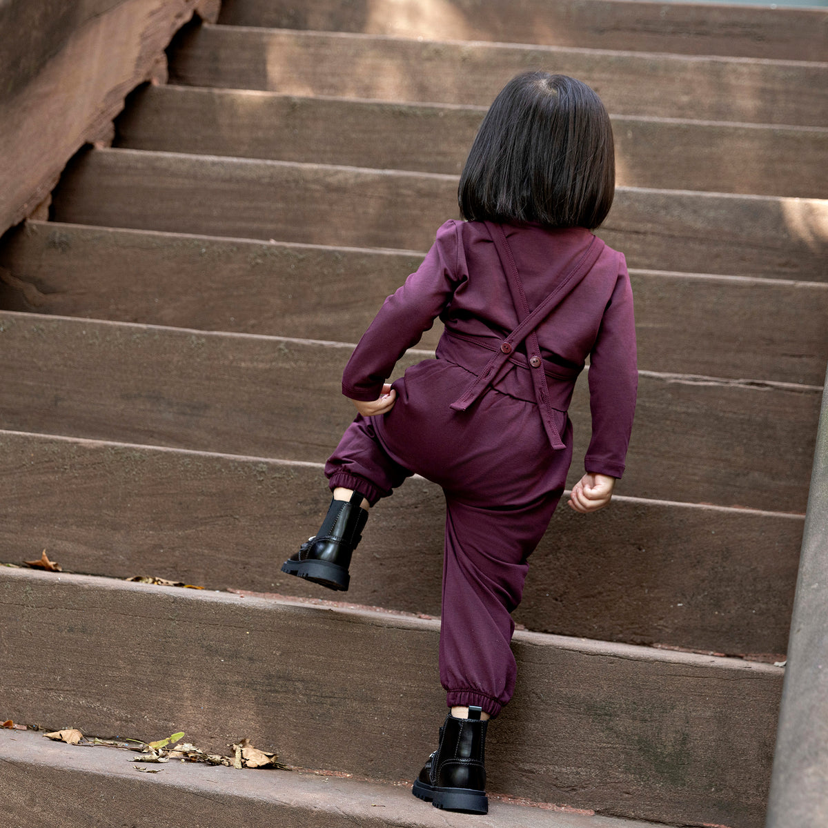 Toddler girl wearing a Rooie and Friends mauve romper with matching mock neck