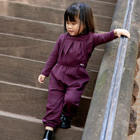 Toddler girl wearing a Rooie and Friends mauve romper with matching mock neck